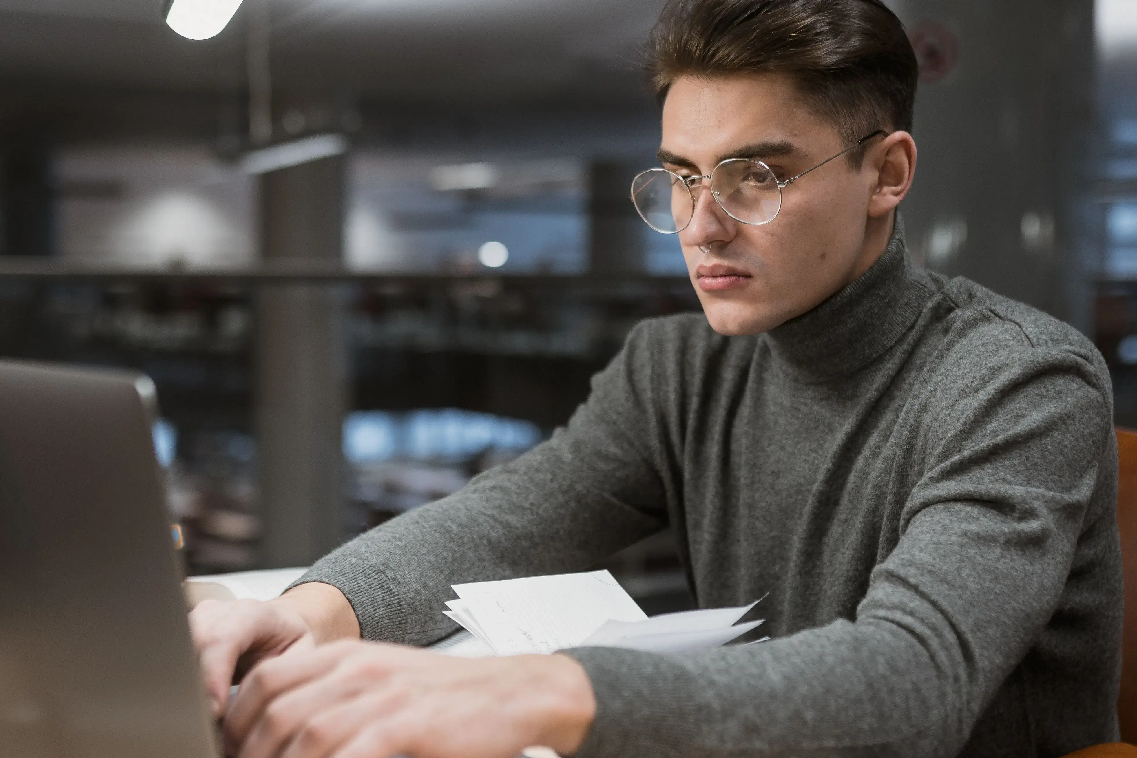 Student checking sources on laptop for research paper